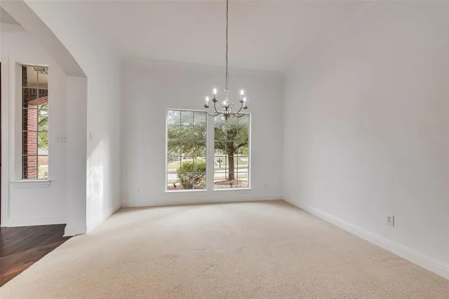 a view of a room with window and chandelier