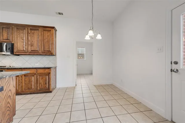 a view of a kitchen with a sink and cabinets