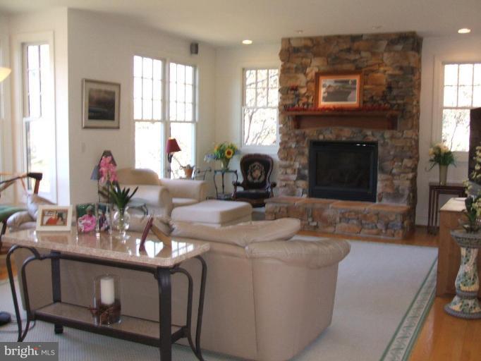 100 A Edgehill Road Annapolis, MD 21405 - Photo 2 of 30 a living room with furniture a fireplace and windows