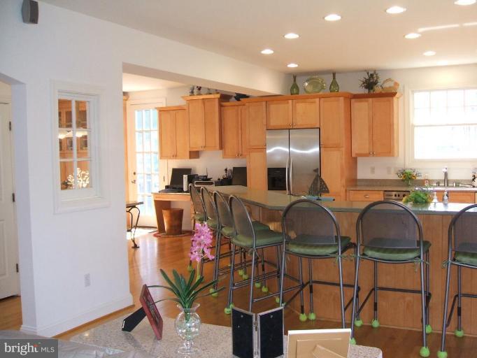 100 A Edgehill Road Annapolis, MD 21405 - Photo 21 of 30 a kitchen with granite countertop lots of white cabinets a sink a window and a couch