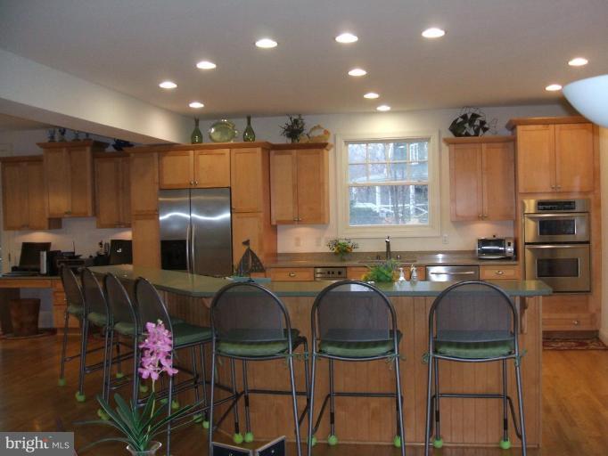 100 A Edgehill Road Annapolis, MD 21405 - Photo 5 of 30 a kitchen with stainless steel appliances a dining table chairs and refrigerator