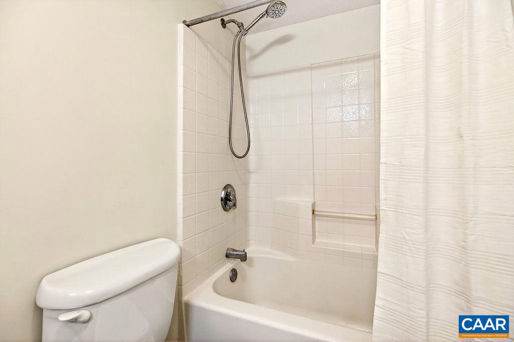 2084 Stone Ridge Wintergreen, VA 22967 - Photo 29 of 41 a white bath tub sitting next to a white toilet and a shower curtain