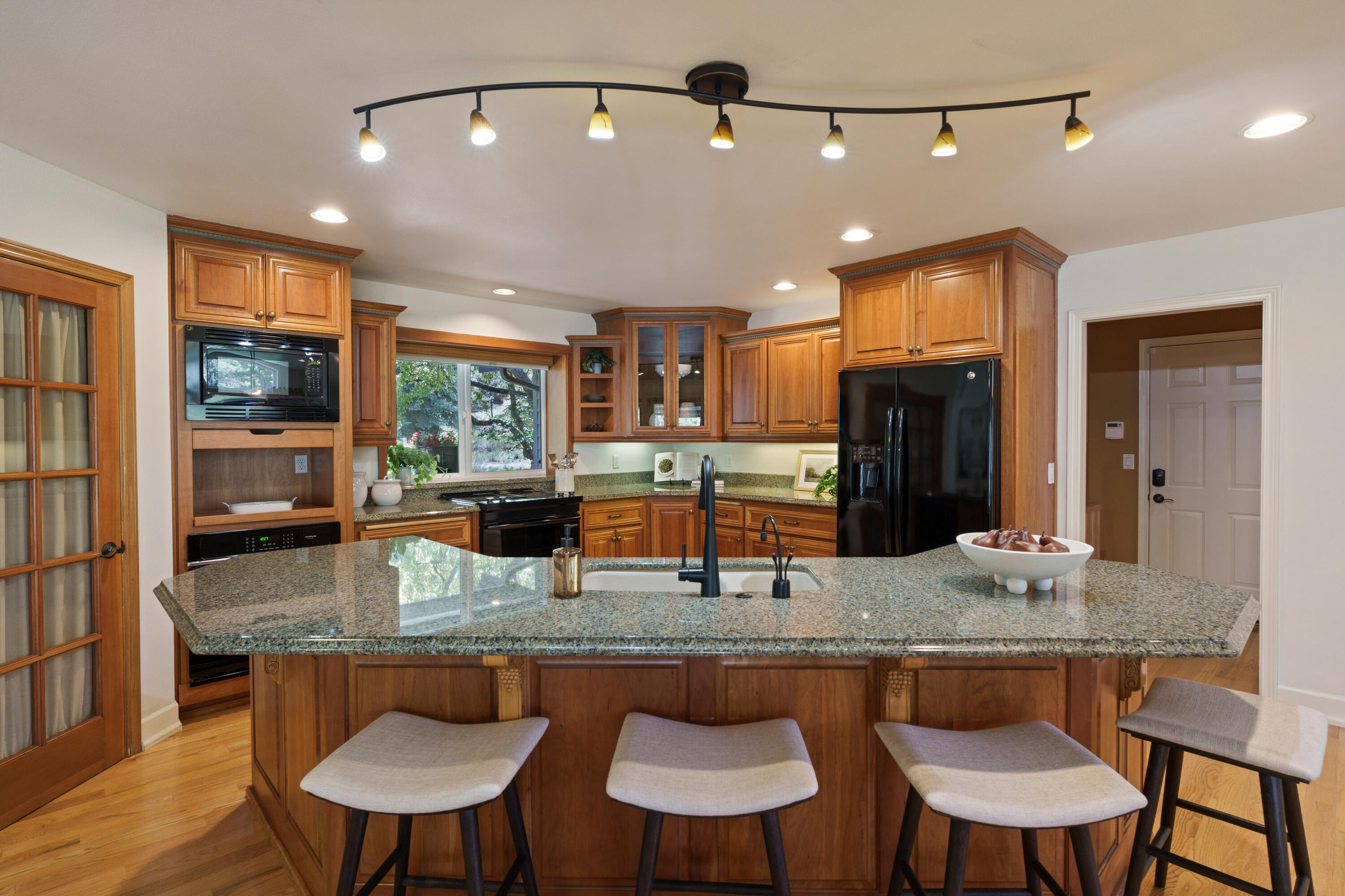 18880 Baker Road Bend, OR 97702 - Photo 34 of 70 a kitchen with granite countertop kitchen island a table and chairs in it