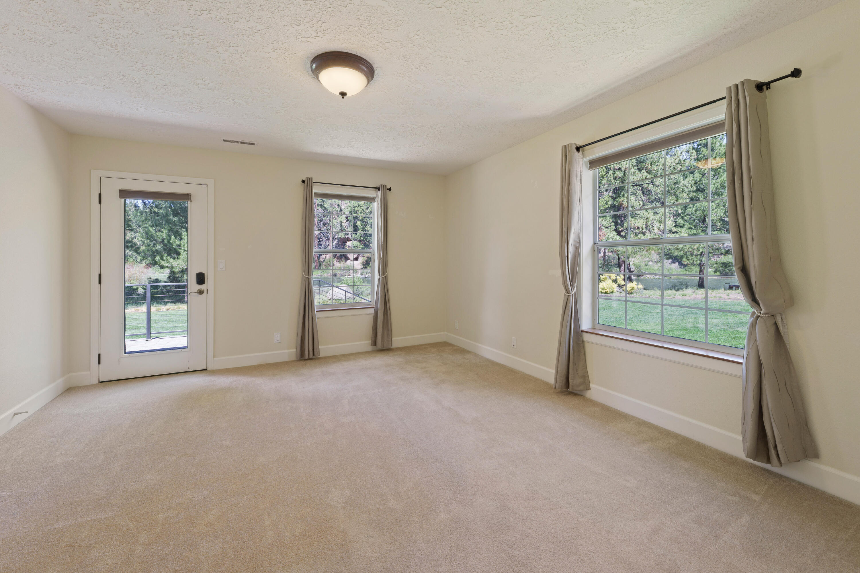 18880 Baker Road Bend, OR 97702 - Photo 47 of 70 a view of a big room with windows and chandelier fan