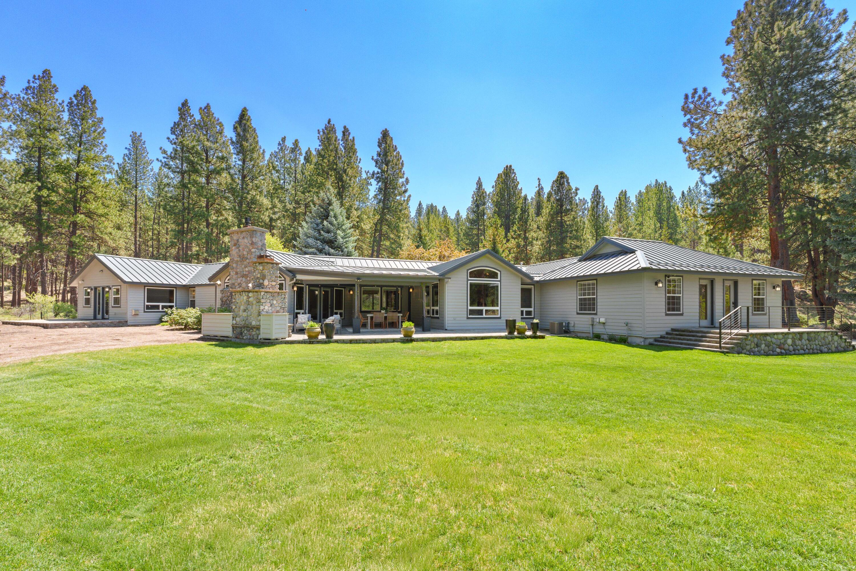 18880 Baker Road Bend, OR 97702 - Photo 56 of 70 a front view of a house with yard garden and trees