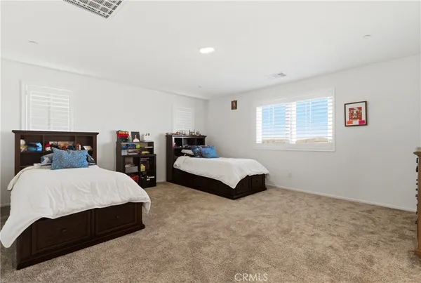 a spacious bedroom with a bed and window
