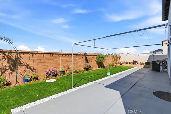 a view of a garden with wooden fence