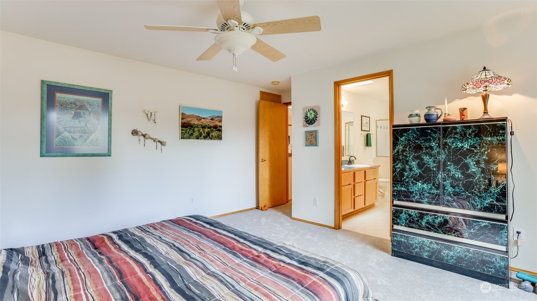 27728 211th Court Southeast Maple Valley, WA 98038 - Photo 17 of 23 a bedroom with a bed and a chandelier fan