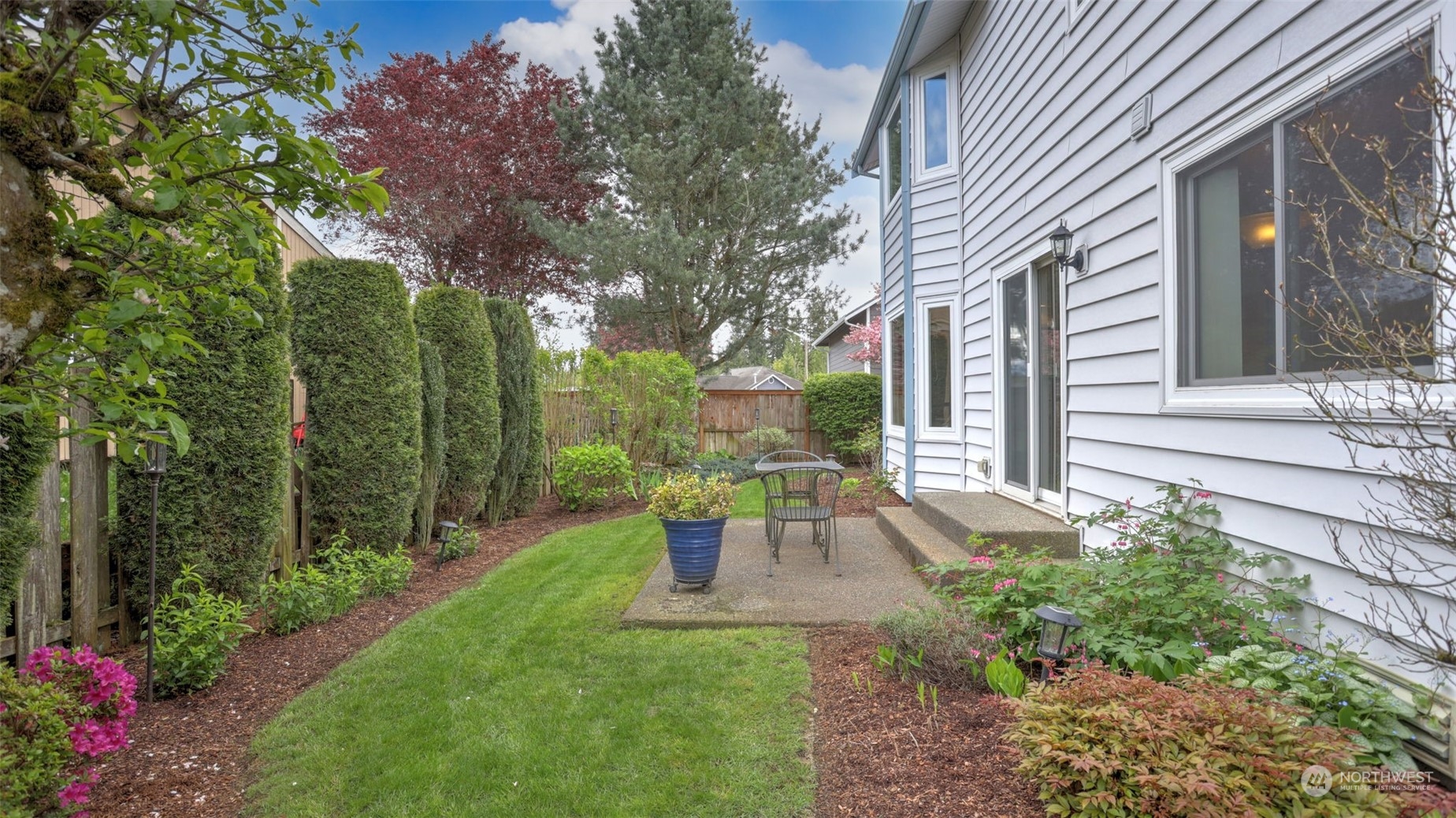 27728 211th Court Southeast Maple Valley, WA 98038 - Photo 20 of 23 a view of a house with backyard sitting area and garden