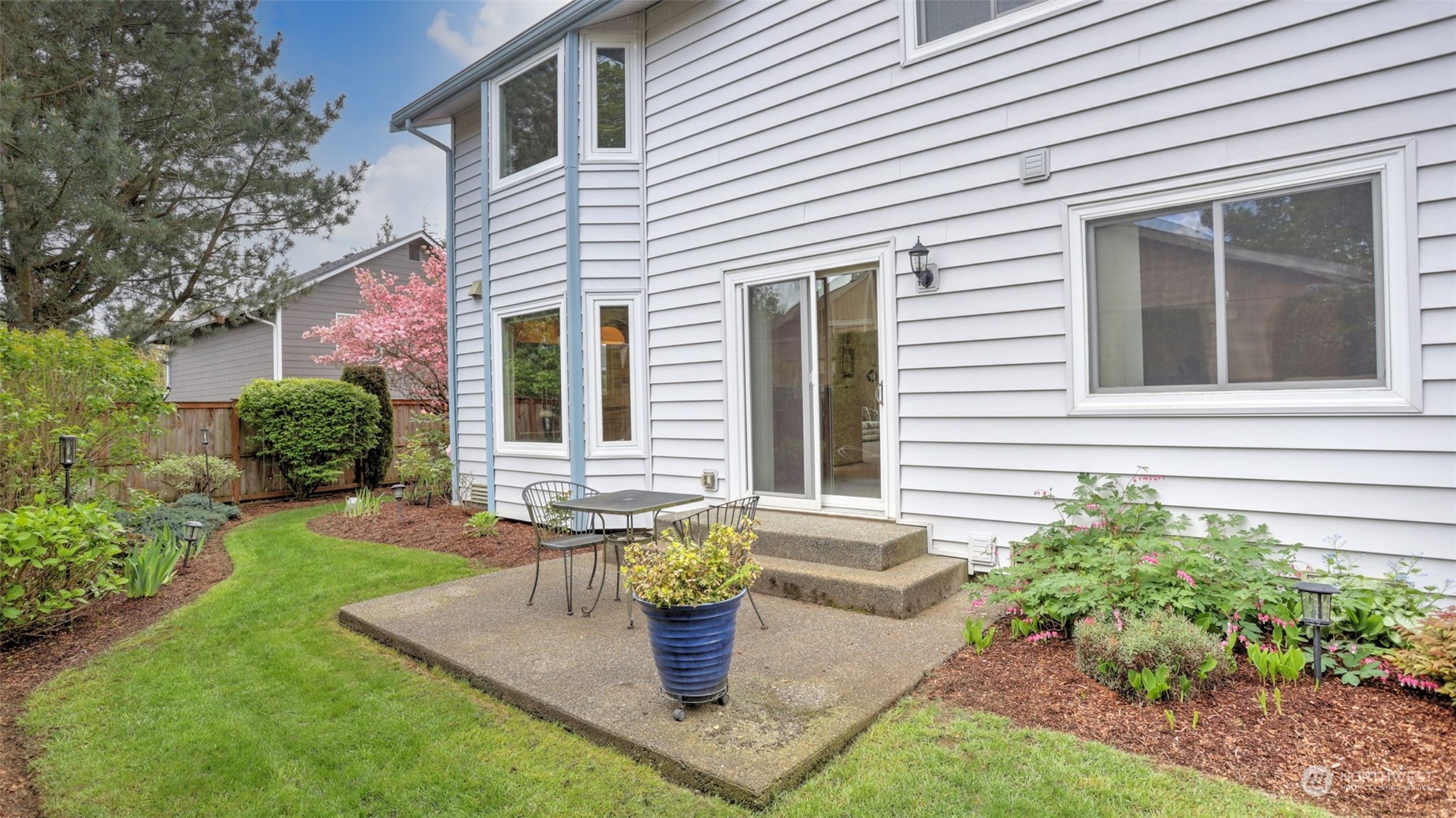 27728 211th Court Southeast Maple Valley, WA 98038 - Photo 21 of 23 a view of a house with backyard sitting area and garden