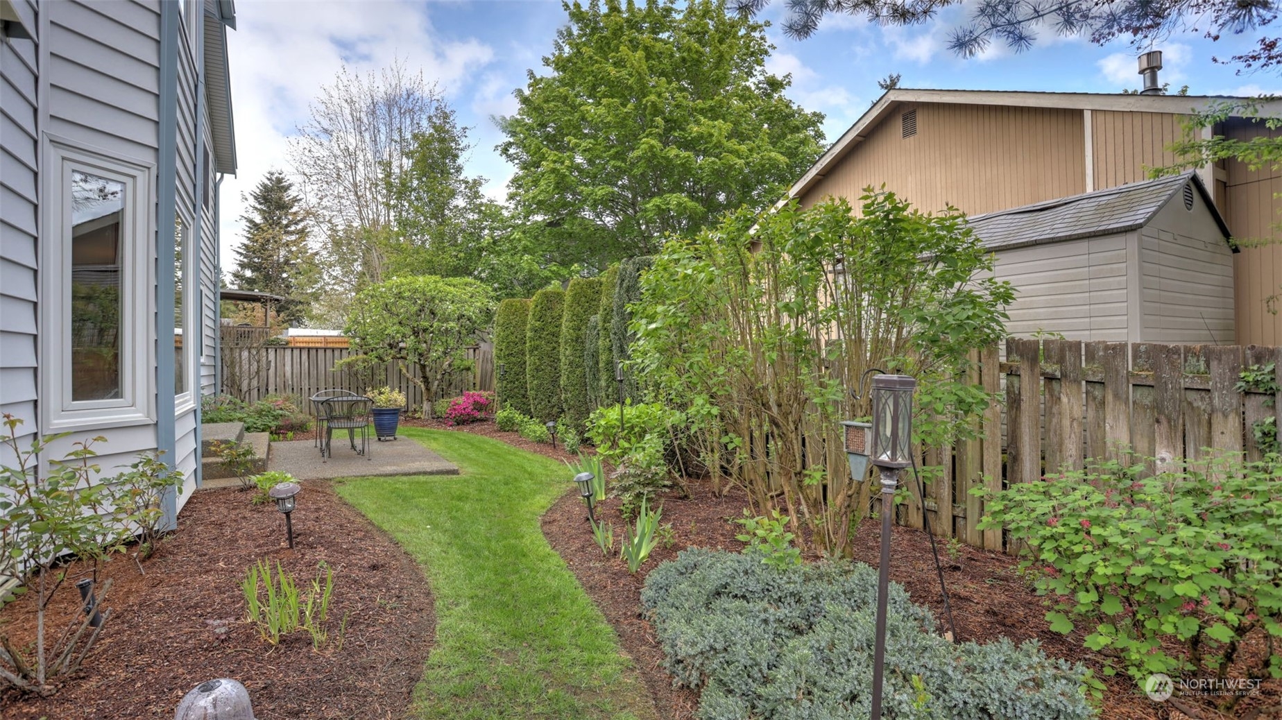 27728 211th Court Southeast Maple Valley, WA 98038 - Photo 22 of 23 a front view of a house with garden