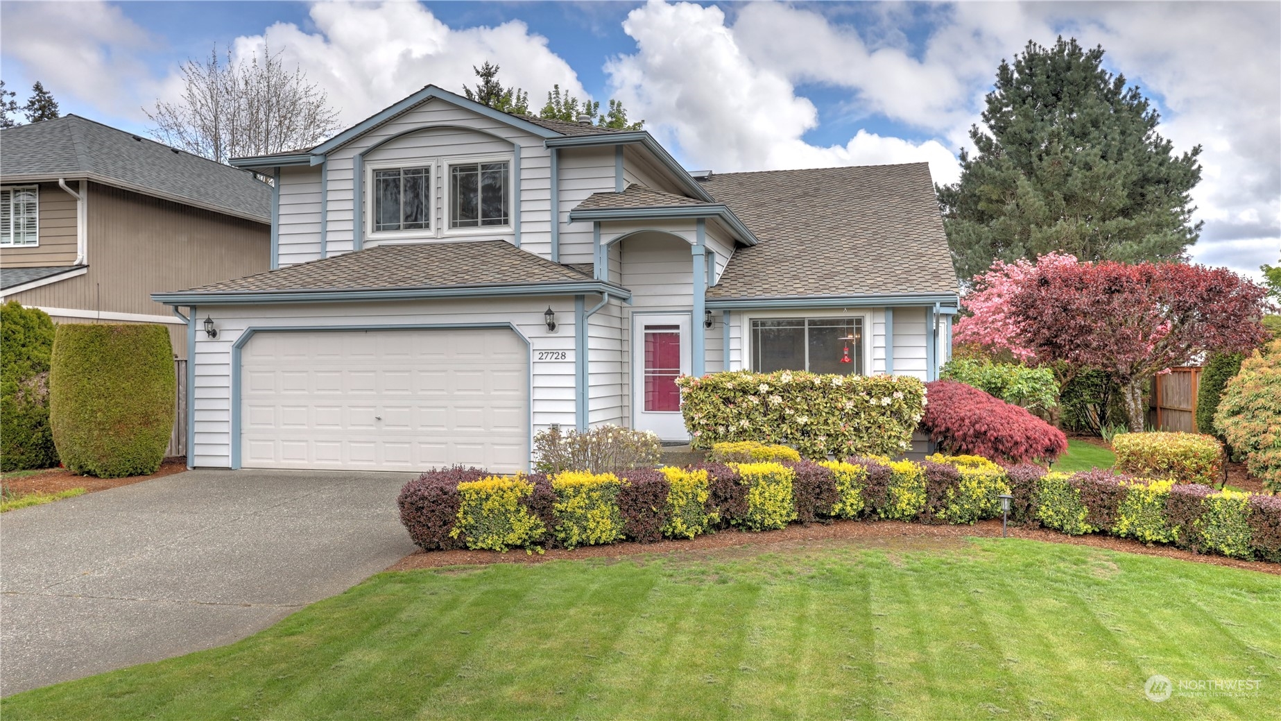 27728 211th Court Southeast Maple Valley, WA 98038 - Photo 23 of 23 a front view of a house with a garden and plants