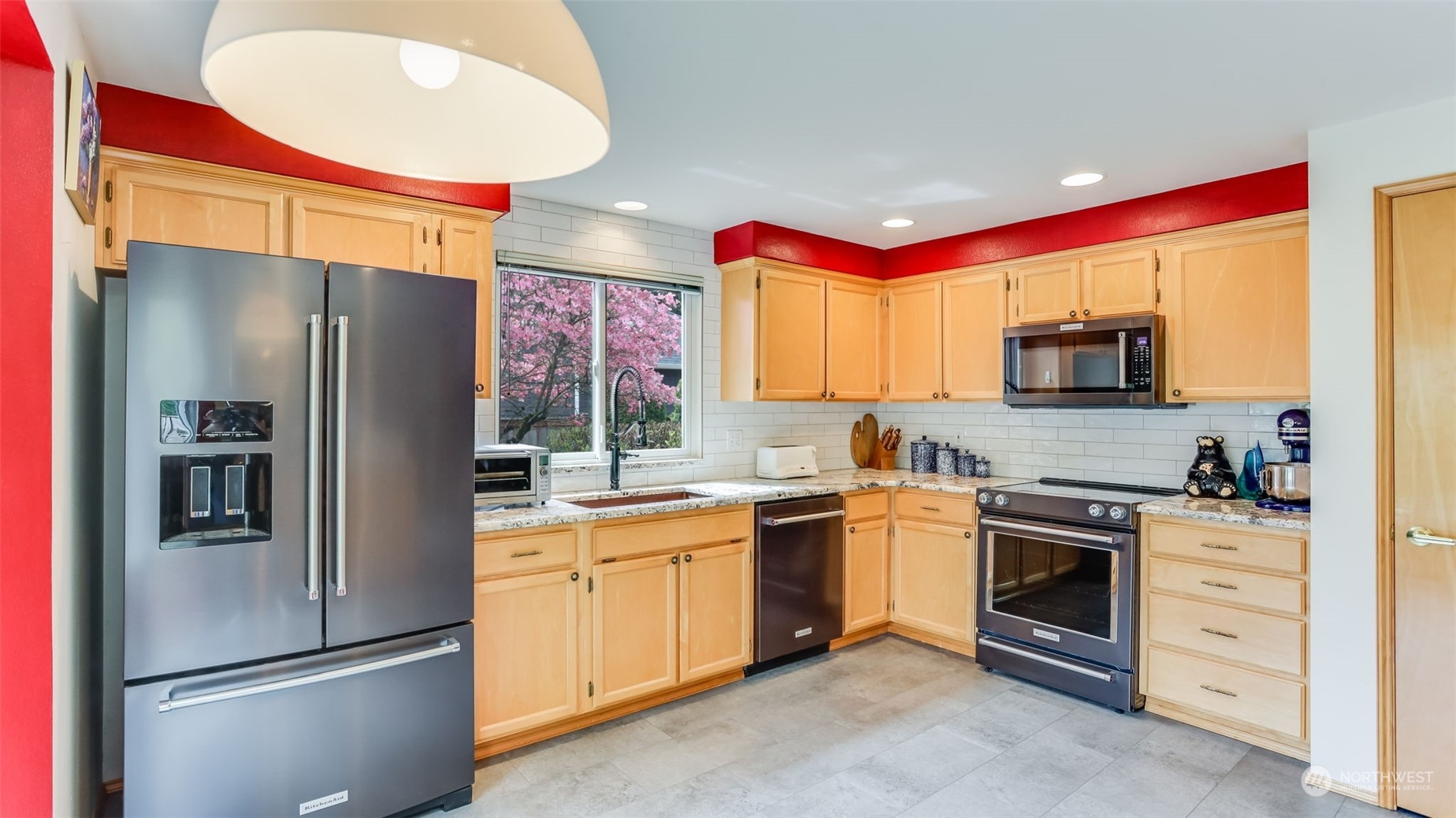 27728 211th Court Southeast Maple Valley, WA 98038 - Photo 5 of 23 a kitchen with stainless steel appliances granite countertop a refrigerator sink and stove