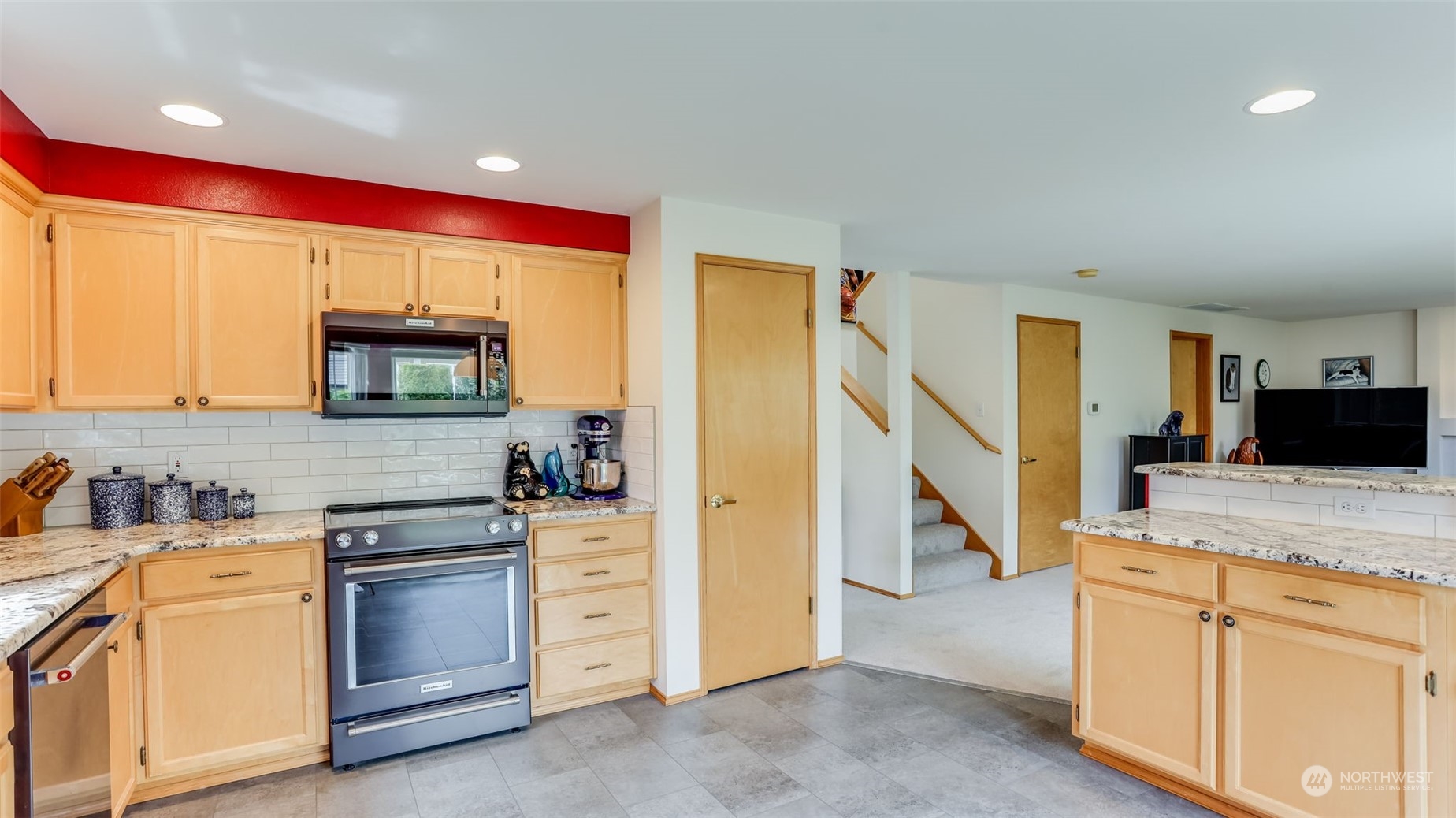 27728 211th Court Southeast Maple Valley, WA 98038 - Photo 6 of 23 a kitchen with stainless steel appliances granite countertop a stove a sink and a refrigerator