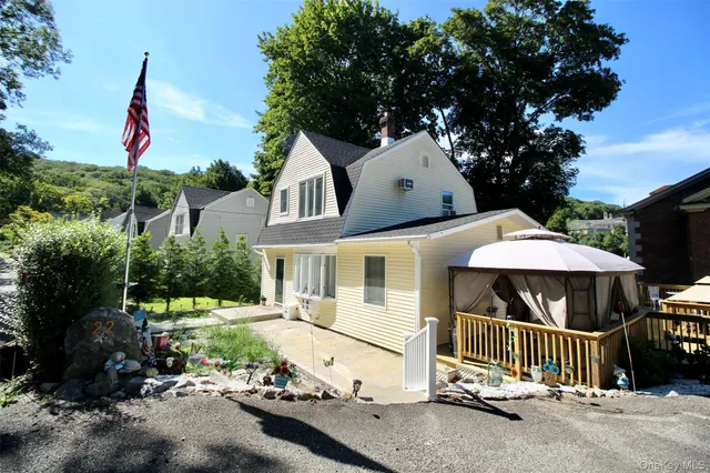 a view of a house with a yard and sitting area