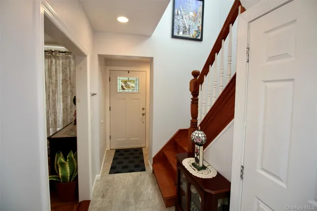 a view of entryway and hall with wooden floor
