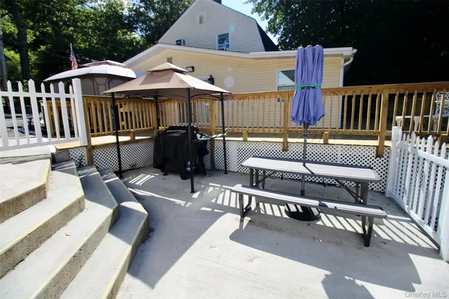 a view of a patio with a table and chairs