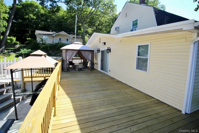 a view of a house with wooden deck