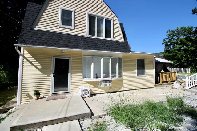 a view of a house with a yard and sitting space