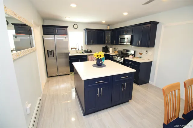a kitchen with stainless steel appliances a refrigerator sink and microwave
