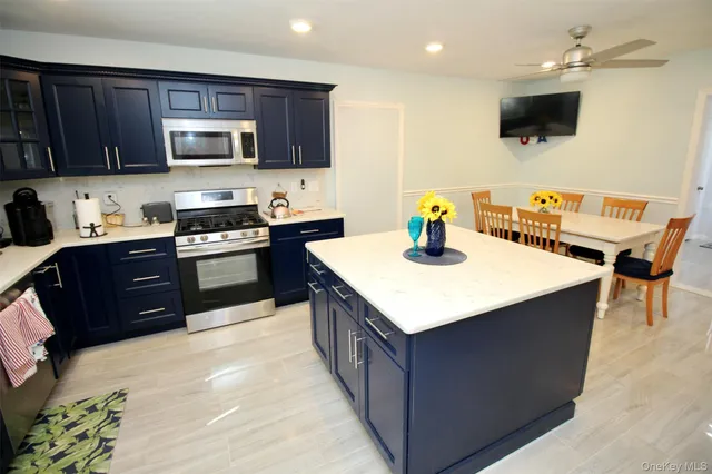 a kitchen with a stove top oven a sink dishwasher and a refrigerator with wooden cabinets