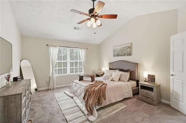 a bedroom with bed and a window