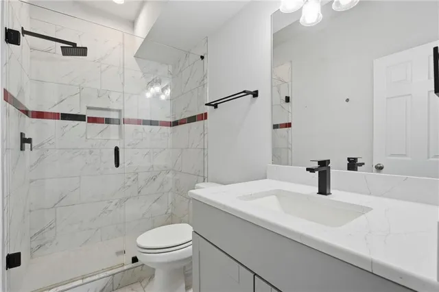 a bathroom with a sink toilet and shower