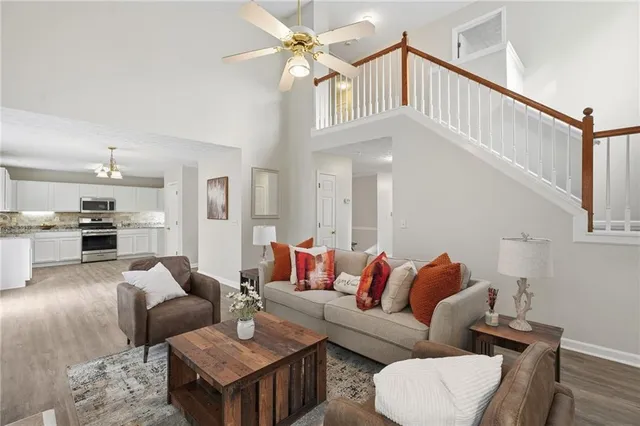 a living room with furniture and kitchen view