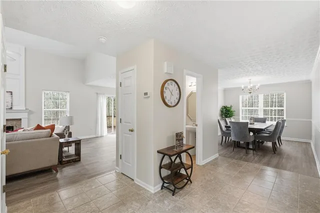 a living room with furniture a clock and a large window