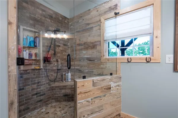 a bathroom with a shower and a sink