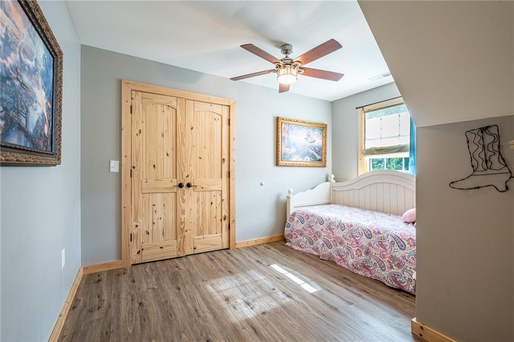 286 County Road 28 Centre, AL 35960 - Photo 16 of 50 a bedroom with a bed and a chandelier