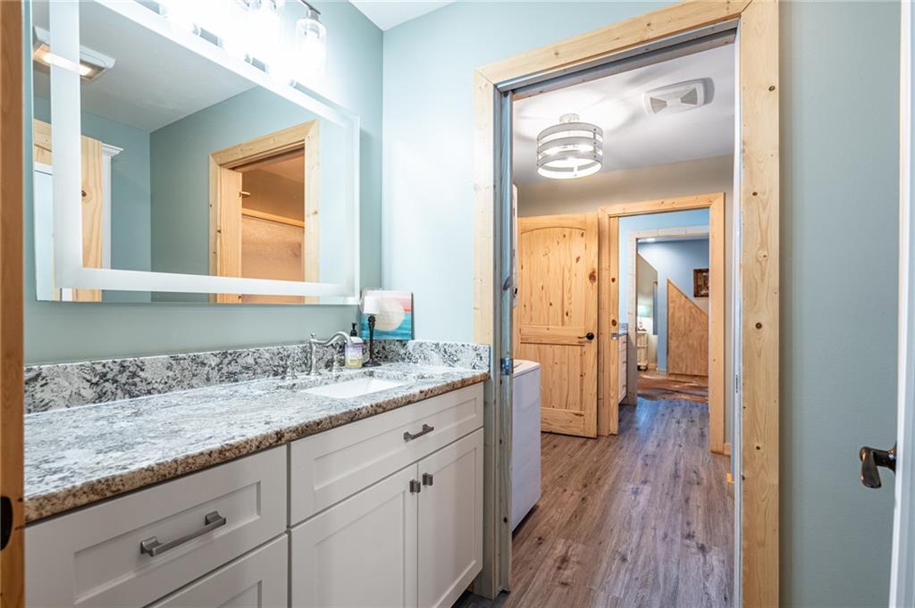 286 County Road 28 Centre, AL 35960 - Photo 18 of 50 a en suite bathroom with a granite countertop sink mirror and a toilet