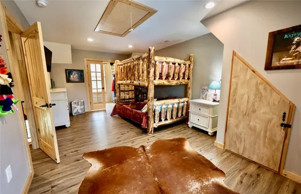 a spacious bedroom with a bed couch and a window