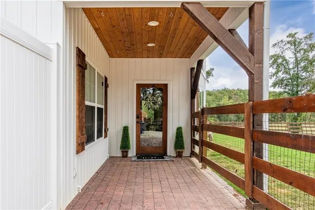 a view of a porch with wooden floor and stairs