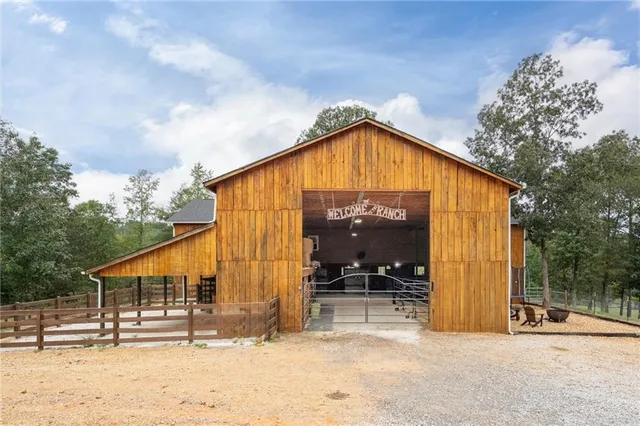 a view of a house with a wooden fence
