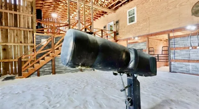 a kitchen with stainless steel appliances granite countertop a refrigerator a sink dishwasher a stove and a dining table with wooden floor