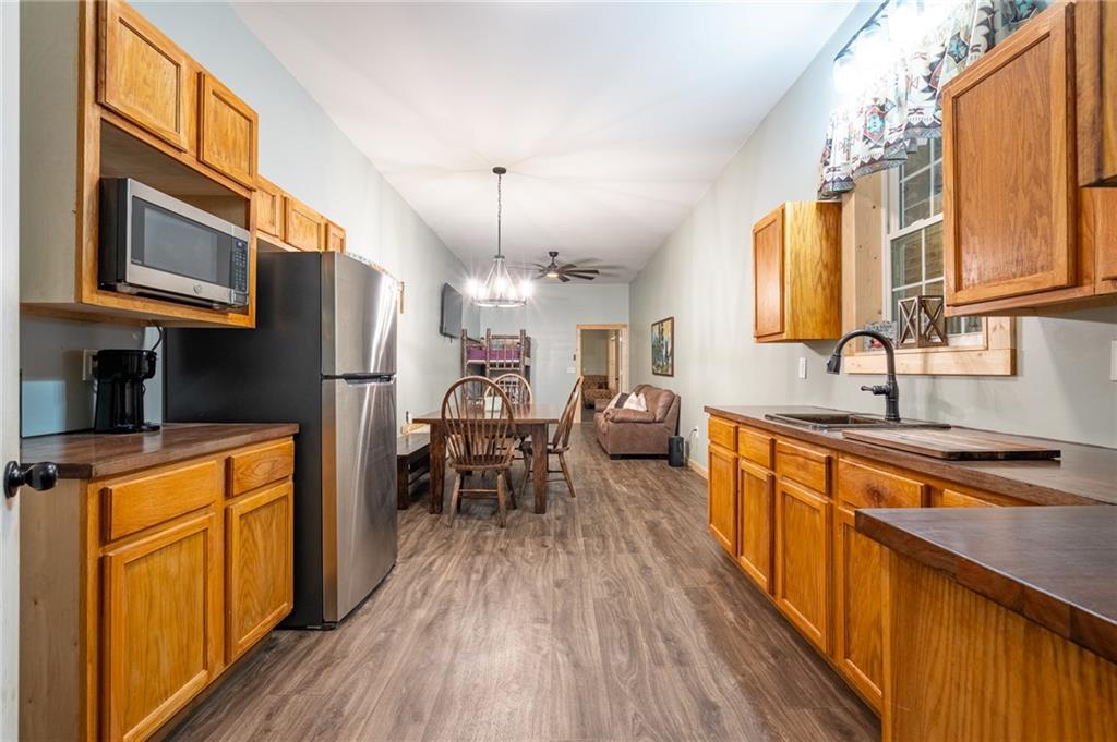 286 County Road 28 Centre, AL 35960 - Photo 41 of 50 a kitchen with stainless steel appliances granite countertop a refrigerator a sink dishwasher a stove and a dining table with wooden floor