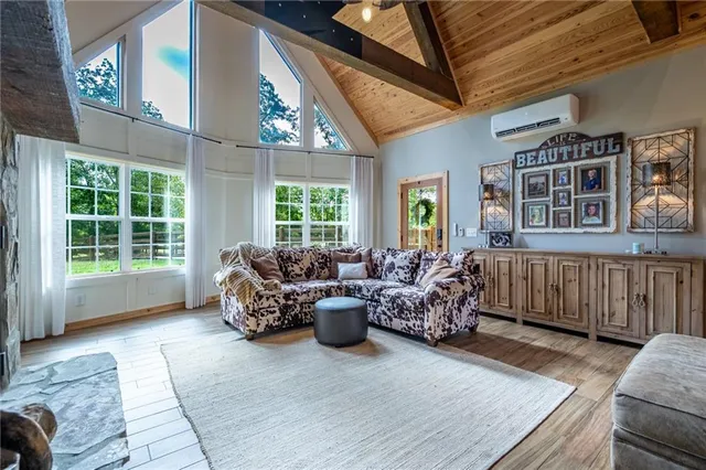 a living room with furniture stairs and a large window