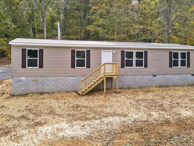 a backyard of a house with barbeque oven
