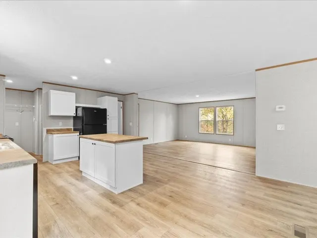 a view of kitchen with microwave a stove and cabinets