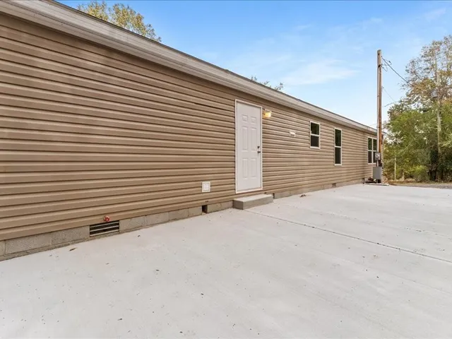a view of a house with a yard and garage