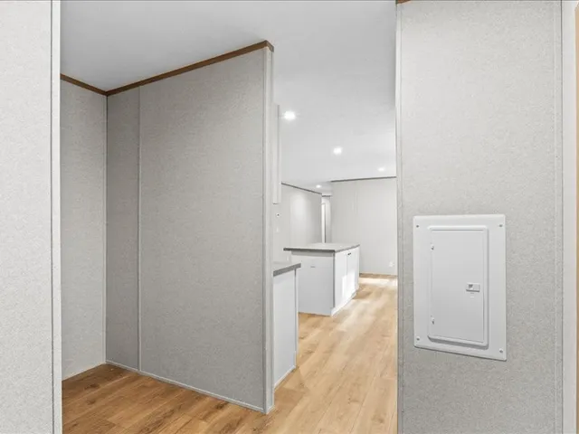 a view of a kitchen with a refrigerator and wooden floor