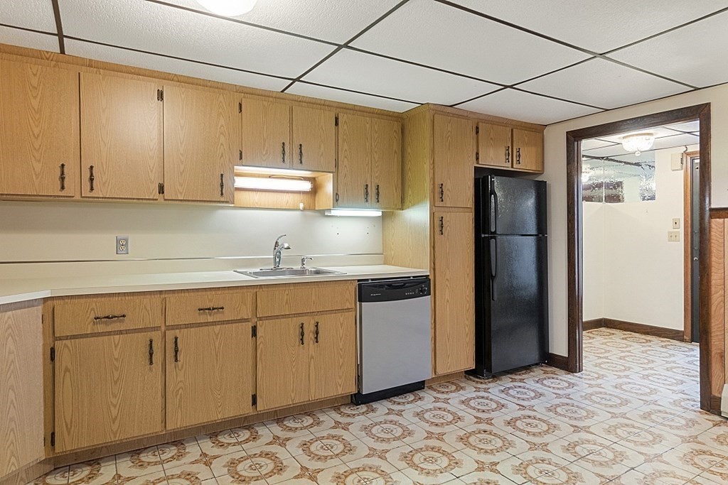 120 Birch Street Boston, MA 02131 - Photo 24 of 42 a kitchen with stainless steel appliances granite countertop a refrigerator and a stove top oven