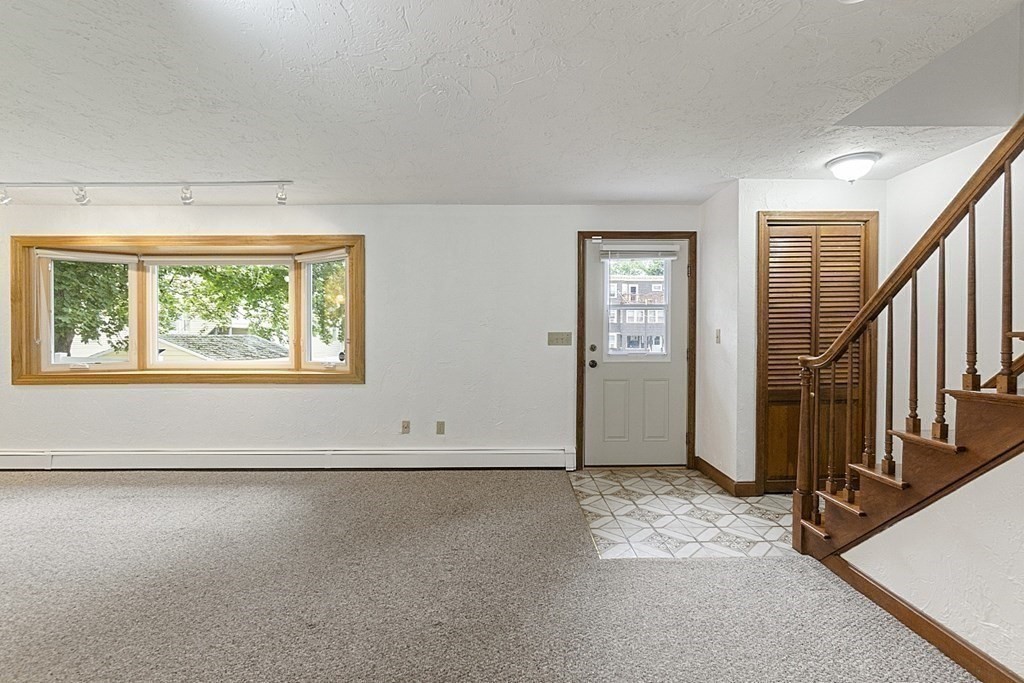 120 Birch Street Boston, MA 02131 - Photo 5 of 42 an empty room with windows