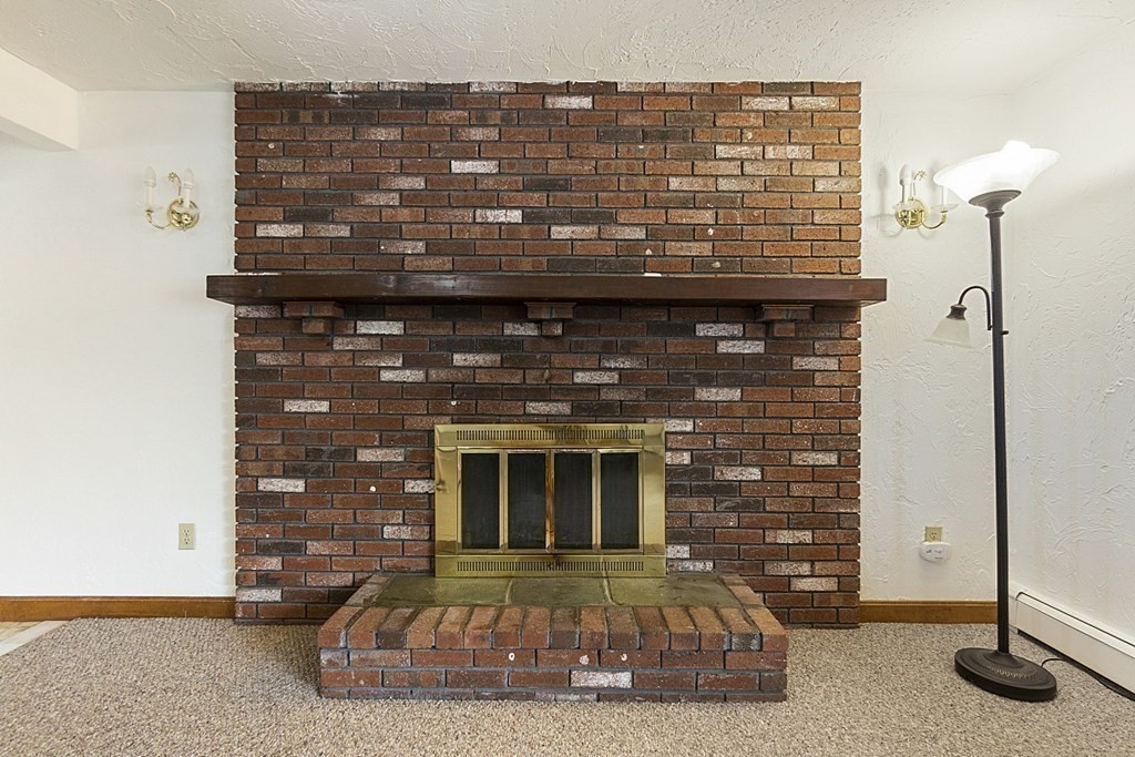 120 Birch Street Boston, MA 02131 - Photo 6 of 42 a view of a fireplace with wooden door