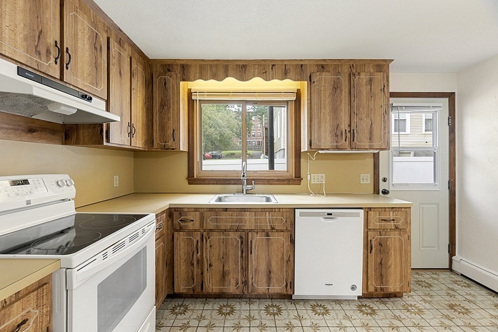 120 Birch Street Boston, MA 02131 - Photo 8 of 42 a kitchen with a sink stove and cabinets