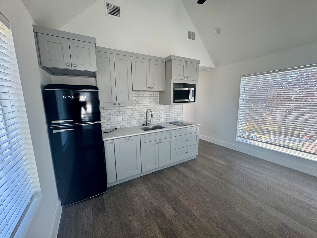 1916 Webberville Road, Unit C Austin, TX 78721 - Photo 7 of 10 a kitchen with a refrigerator sink and cabinets