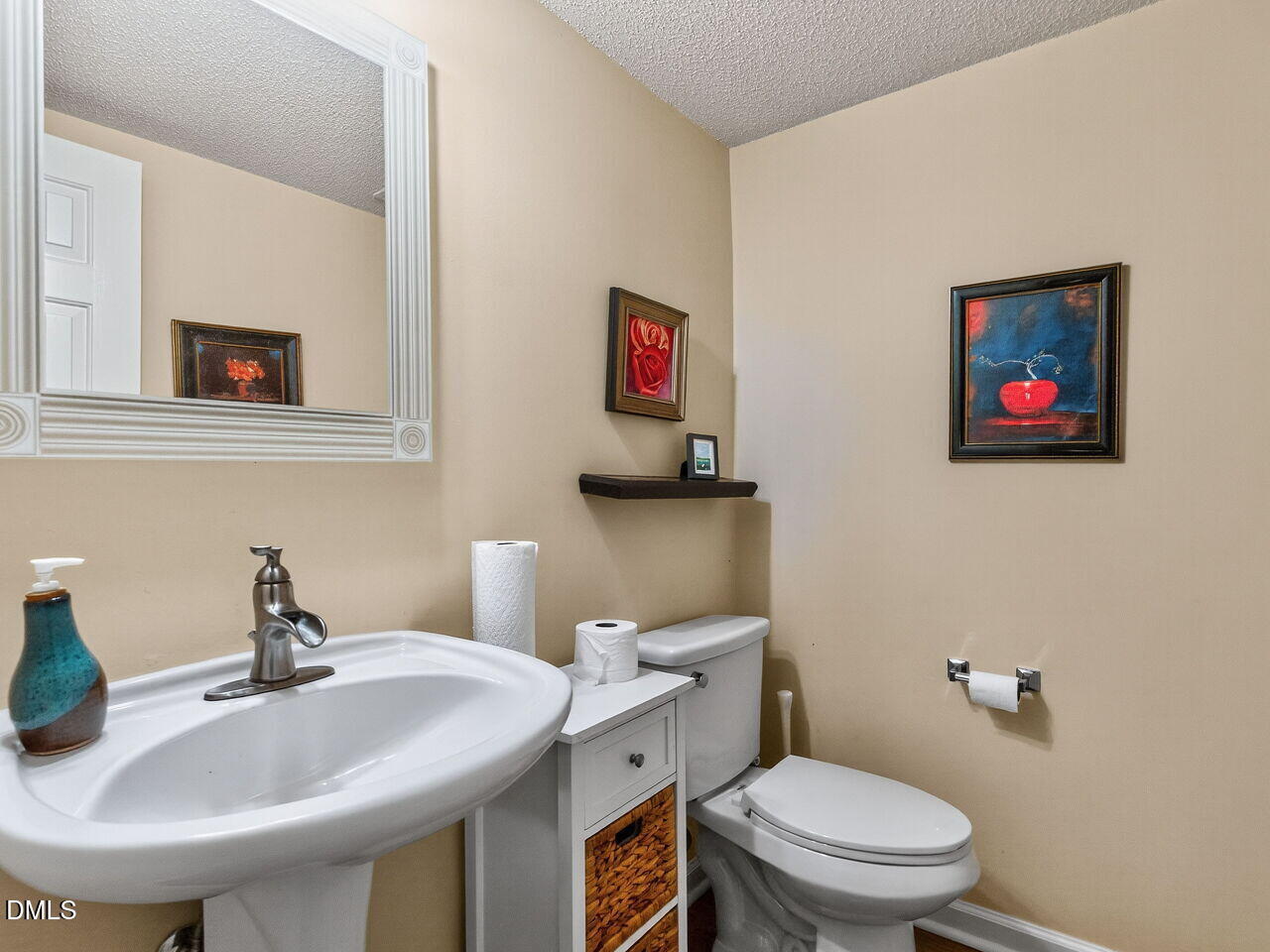 2658 Garden Knoll Lane Raleigh, NC 27614 - Photo 13 of 29 a bathroom with a toilet a sink and a mirror