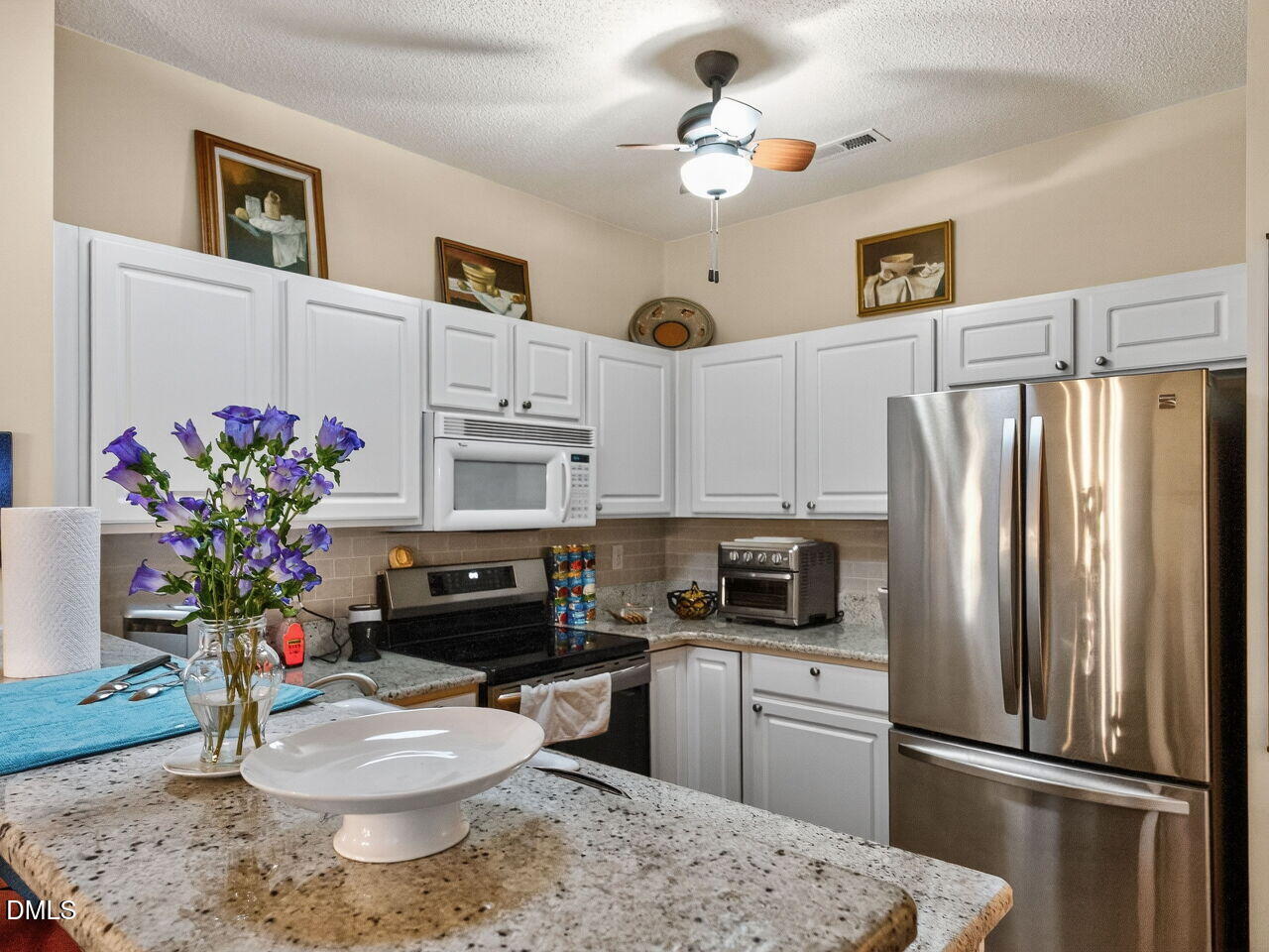 2658 Garden Knoll Lane Raleigh, NC 27614 - Photo 8 of 29 a kitchen with a refrigerator and microwave