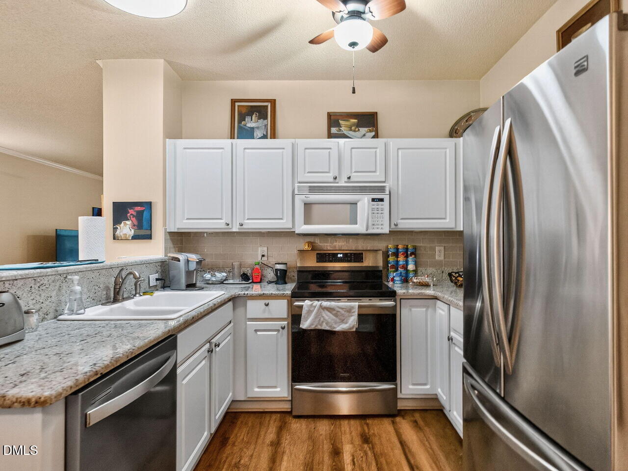2658 Garden Knoll Lane Raleigh, NC 27614 - Photo 10 of 29 a kitchen with stainless steel appliances granite countertop a refrigerator sink and stove